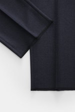 Close-up top-down view of Zegna Suit 'Trofeo' navy melange fabric showing subtle check pattern and soft pure wool texture, Slim Fit. The classic 'Trofeo' by ZEGNA impresses with its versatility and exclusive wool quality, making the suit a safe choice for