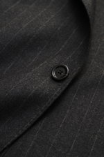 Close-up front view of Lardini Suit anthracite/grey striped fabric showing a black button on soft cashmere virgin wool blend with classic pinstripe.
