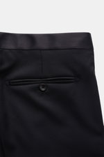 Close-up rear view of Tagliatore Tuxedo 'Napoli' dark navy trousers showing satin-finished waistband, buttoned back pocket, and fine twill texture.

Italian eveningwear to meet the dress code: Draw attention to yourself in style with the elegant tuxedo 'N
