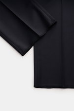 Close-up top-down view of Tagliatore Tuxedo 'Napoli' dark navy fabric in pure Super 110'S virgin wool, showing fine twill texture and smooth edges.