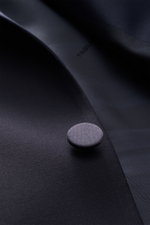 Close-up front angle of navy fabric and button detail on the Tagliatore Tuxedo navy, Italian evening wear in pure Super 110'S virgin wool. Italian evening wear for elegant occasions: Draw attention to yourself in style with this classy tuxedo in pure Supe