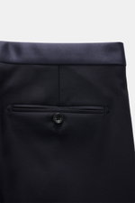 Close-up rear view of the Tagliatore Tuxedo navy trousers in pure Super 110'S virgin wool, showing buttoned back pocket and satin waistband.