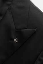 Close-up front view of the Tagliatore Tuxedo black lapel in pure Super 110'S virgin wool with a slim fit, satin facing, and signature pin.