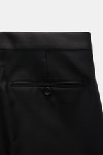 Close-up rear view of the waistband and back pocket of Tagliatore Tuxedo black trousers in pure Super 110'S virgin wool, slim fit with satin waistband and buttoned back pocket.