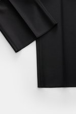 Close-up front view of Tagliatore Tuxedo black trousers in pure Super 110’S virgin wool, showing smooth fabric and slim fit details.