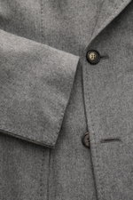 Close-up front view of Sipario Smart-casual jacket 'Ivan' grey melange showing soft cashmere blend, double-breasted two-button style, pointed lapel, classic breast pocket, patch hip pockets, unfinished sleeve cuffs, side vents, half lining, and three insi