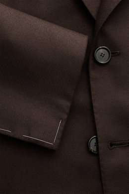 Close-up front view of the Cesare Attolini Cashmere jacket dark brown showing soft pure cashmere fabric, slim fit with fitted three-button style, step lapel, classic breast pocket, patch hip pockets, unfinished sleeve cuffs, side vents at the back, half l