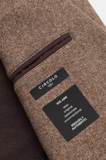 Close-up of the inside breast pocket of the Circolo 1901 Jersey jacket beige/dark brown patterned, showing soft woven look print fabric and brand labels, photographed from the interior side.

<p>This easy-care, modern jersey jacket in a contemporary uncon