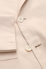 Close-up front view of the Brioni Smart-casual jacket 'New Plume' sand mottled, showing buttons, pointed lapel, and cuff details.