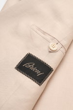 Close-up of the sleeve and label of the Brioni Smart-casual jacket 'New Plume' sand mottled, showing fine silk-cashmere blend fabric and button from a top-down perspective.