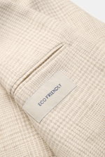 Close-up angled view of the cream/beige checked fabric and pocket detail of the Belvest Smart-casual jacket, featuring an "ECO FRIENDLY" label. BELVEST has brought together the best in natural materials – wool, linen, silk and cashmere – in this summery s