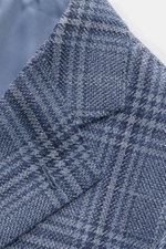 Close-up front detail of Cesare Attolini Smart-casual jacket navy/grey-blue checked showing woven pattern, step lapel, and unfinished sleeve cuff.

<p>Enjoy luxury from CESARE ATTOLINI: This smart-casual jacket with woven checked pattern is exclusively ma