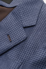 Close-up top-down view of the Zegna Smart-casual jacket 'Atelier' navy/smoky blue checked showing the glen check pattern, step lapel, and stitched buttonhole. A statement piece for the most discerning tastes: The 'Atelier' smart-casual jacket by ZEGNA com