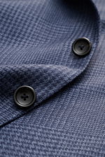 Close-up view of the Zegna Smart-casual jacket 'Atelier' navy/smoky blue checked fabric and buttons, highlighting texture and craftsmanship.

<p>A statement piece for the most discerning tastes: The 'Atelier' smart-casual jacket by <span class="hover:enti