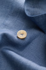 Close-up front view of the Santaniello Smart-casual jacket grey-blue mottled showing fine wool-linen fabric texture and a beige button.

<p>Classic elegance for the new season: This double-breasted smart-casual jacket by SANTANIELLO in fine wool with line