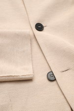 Close-up top view of Harris Wharf London Knit blazer beige showing pure piqué cotton fabric, black buttons, and patch pocket detail. 

Description: <p>HARRIS WHARF LONDON has chosen a high-quality cloth from Loro Piana for this relaxed knit blazer. Pure c