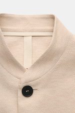 Harris Wharf London Knit blazer beige shown from a close-up front perspective, highlighting pure piqué cotton, open edge finish, and a black button detail. 

<p>HARRIS WHARF LONDON has chosen a high-quality cloth from Loro Piana for this relaxed knit blaz