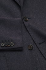 Close-up front view of the Corneliani Blazer grey pattern showing tonal fine herringbone silk-cashmere blend fabric, soft touch, slim fit two-button style with notched lapel, classic breast pocket, patch hip pockets, kissing buttons, rear side vents, unco