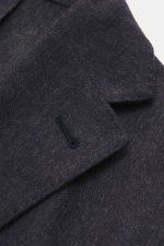Close-up front view of Corneliani Blazer grey pattern showcasing the soft silk-cashmere blend with tonal fine herringbone weave. Crafted with optimal fit by Italian master CORNELIANI, this blazer features a slim fit, tailored two-button style, notched lap