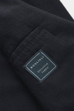 Close-up view of navy fabric and label of the Boglioli Cashmere jersey blazer 'K. Jacket' showcasing soft, lightweight pure cashmere material.
