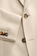 Close-up front view of Boglioli Beige Melange Knit Blazer showing fine knit texture, buttons, and sleeve details.

<p>Exquisite knit blazer by BOGLIOLI: Crafted from a luxurious silk-cashmere blend with a refined knit texture, this piece brings effortless