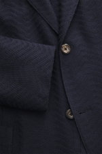 Close-up front view of Emporio Armani Knitted blazer navy showing tonal herringbone knit, two-button style, notched lapel, and patch hip pocket.

Additional description:  
<p>Noble piece with a twist by EMPORIO ARMANI: With this blazer made of fine struct