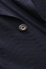 Close-up front view of Emporio Armani Knitted blazer navy showing textured tonal herringbone knit, button, and lapel detail.

Description:  
<p>Noble piece with a twist by EMPORIO ARMANI: With this blazer made of fine structured knit, you are perfectly ri