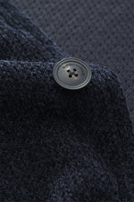 Close-up front view of Emporio Armani Knitted blazer navy showing a chenille high-quality microfiber fabric with a slightly textured feel, featuring a five-button style, draped lapel, patch front pockets, regular fit, and unconstructed design.