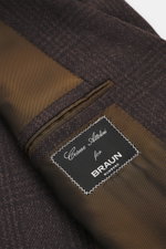 Close-up of the interior label and lining of the Cesare Attolini Cashmere Blazer dark brown/black checkered, photographed from above, showcasing pure cashmere fabric, classic Glen check pattern, and luxurious half-lined design. 

Description: <p>Treat you