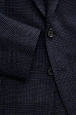 Close-up front angled view of Cesare Attolini Navy/Black Checked Blazer featuring slim fit, tailored three-button style, notched lapel, classic breast pocket, patch hip pockets, unfinished sleeve cuffs, rear side vents, half lined, three inner pockets, so