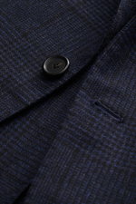 Close-up front angle of Cesare Attolini Navy/Black Checked Blazer showing soft wool and cashmere mix, classic Glencheck pattern, slim fit, tailored three-button style, notched lapel, classic breast pocket, patch hip pockets, unfinished sleeve cuffs, rear 
