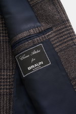 Close-up inside view of the Cesare Attolini Cashmere Blazer taupe/dark brown checked showing navy lining, inner pocket, and brand label.

<p>Indulge in luxury from CESARE ATTOLINI: This timeless blazer is exclusively made in Italy and features a classic G