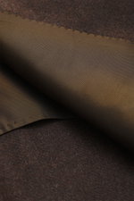 Close-up of the half-lined interior fabric and rich dark brown mélange cashmere exterior of the Cesare Attolini Cashmere Blazer Dark Brown Mélange, photographed from above showcasing the soft touch and fine craftsmanship. <p>Indulge in luxury from CESARE 