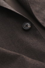 Close-up front angled view of Belvest Cashmere blazer dark brown showing pure cashmere fabric, very soft feel, tonal herringbone weave pattern, slim fit, tailored two-button style, notched lapel with brand-typical pin, classic breast pocket, hip pockets w