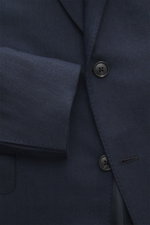 Close-up front view of the Belvest Cashmere blazer navy, showcasing pure cashmere, very soft feel, tonal herringbone weave pattern, slim fit, tailored two-button style, notched lapel with brand-typical pin, classic breast pocket, hip pockets with flap, un