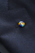 Close-up front view of Belvest Cashmere blazer navy showing tonal herringbone weave, colorful brand-typical pin on notched lapel, pure cashmere, very soft feel, slim fit, tailored two-button style, classic breast pocket, hip pockets with flap, unfinished 