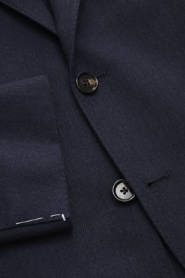 Close-up front view of the Borrelli Blazer 'Procida' grey blue showing slim fit, tonal subtle herringbone, three-button style, notched lapel, classic chest pocket, patch hip pockets, unfinished sleeve ends, rear side vents, half lined, two inside pockets,