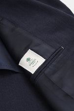 Close-up view of the interior and fabric of the Borrelli Blazer 'Procida' grey blue, showing the blend of virgin wool and cashmere with a soft feel and tonal subtle herringbone. Slim fit, tailored three-button style with notched lapel, classic chest pocke
