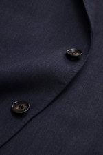 Close-up front view of Borrelli Blazer 'Procida' grey blue showing tonal subtle herringbone fabric, two black buttons, and soft feel mix of virgin wool and cashmere, Slim Fit, tailored three-button style, notched lapel, classic chest pocket, patch hip poc