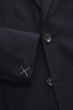 Close-up front view of Colombo Kid Cashmere Blazer 'Robert' navy showing soft pure kid cashmere fabric, notched lapel, two-button style, classic breast pocket, patch hip pocket, unfinished sleeve cuff with white thread, and branded button. In the ultra-li