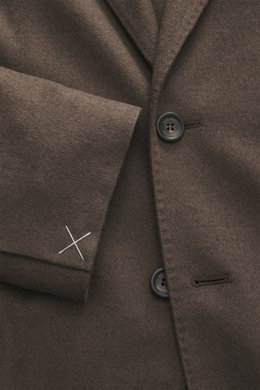 Close-up front view of Colombo Kid Cashmere Blazer 'Robert' taupe, showcasing soft kid cashmere, notched lapel, tailored two-button style, classic breast pocket, patch hip pockets, unfinished sleeve cuffs with white stitching, and branded button.
