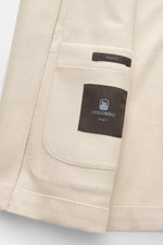Close-up of the inner pocket area of the Colombo Kid Cashmere Blazer 'Robert' cream, photographed from the inside showing the label and fabric texture.

Description:
<p>In the ultra-light quality of soft Yangir Cashmere, the unconstructed blazer 'Robert' 