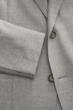 Close-up front view of Lardini Jersey Blazer grey melange showcasing slim fit, elastic virgin wool jersey fabric, soft touch, tailored two-button style, notched lapel with flower pin, classic breast pocket, patch hip pockets, unfinished sleeve ends, rear 