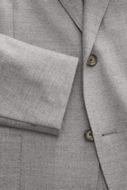 Close-up front view of Lardini Jersey Blazer grey melange showcasing slim fit, elastic virgin wool jersey fabric, soft touch, tailored two-button style, notched lapel with flower pin, classic breast pocket, patch hip pockets, unfinished sleeve ends, rear 