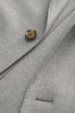 Lardini Jersey Blazer grey melange close-up from above showing elastic virgin wool jersey, slim fit, tailored two-button style, soft touch, notched lapel with flower pin, classic breast pocket, patch hip pockets, unfinished sleeve ends, rear side vents, u
