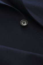 Close-up front angle of the Lardini Jersey Blazer navy showing elastic virgin wool fabric, soft touch, slim fit, two-button style, notched lapel with flower pin, classic breast pocket, patch hip pockets, unfinished sleeve ends, rear side vents, unconstruc