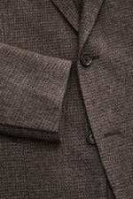 Close-up front view of Lardini Blazer grey-brown patterned showing slim fit, tailored two-button style, notched lapel with flower pin, classic breast pocket, patch hip pockets, unfinished sleeve hems, mix of wool and microfiber, soft feel, subtle check pa