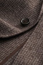 Close-up front angle of Lardini Blazer grey-brown patterned showing wool microfiber fabric, soft feel, subtle check pattern, slim fit, tailored two-button style, notched lapel with flower pin, classic breast pocket, patch hip pockets, unfinished sleeve he