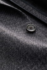 Close-up angled view of Lardini Blazer dark grey melange fabric showing soft, airy woven structure with subtle tonal Glencheck, single button, and unconstructed design. Mix of wool, microfiber and cotton, slim fit, fitted two-button style, notched lapel w