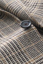 Close-up front-angle view of Lardini Blazer Beige/Dark Brown Checked featuring pure virgin wool, soft touch, Glencheck woven pattern, slim fit, tailored two-button style, notched lapel with flower pin, classic breast pocket, patch hip pockets, unfinished 